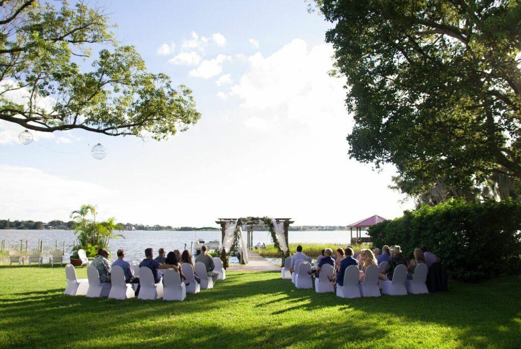guests seated for wedding ceremony outdoor on river bank