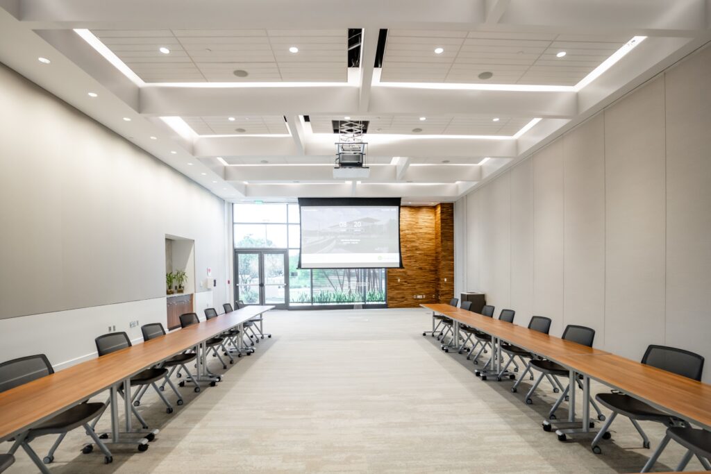 conference room with long tables and projector screen at The Wellvue