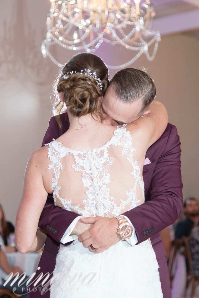 bride and groom hugging on dance floor on their wedding day