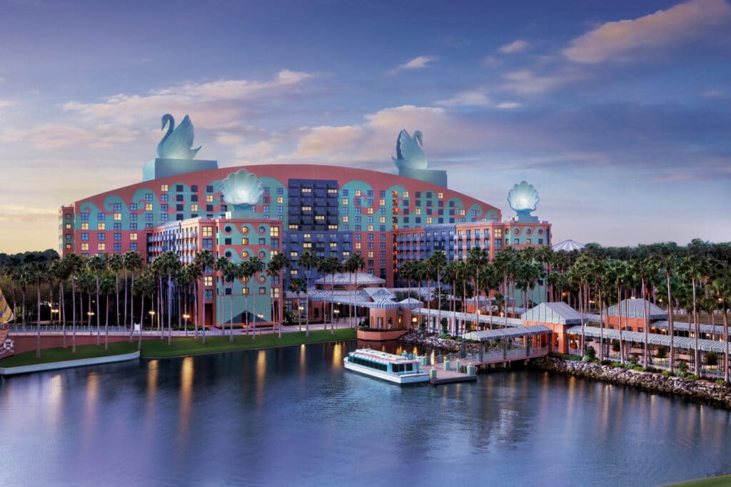 Walt Disney World Swan and Dolphin Resort with water in front of it and boat to transport guests