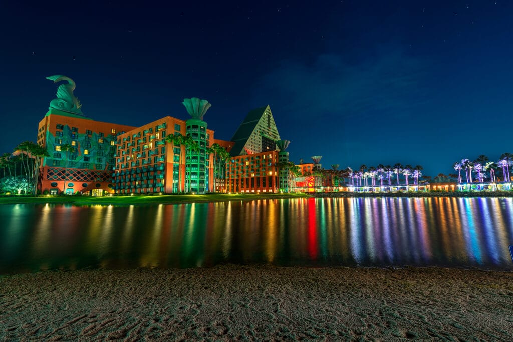Walt Disney World Swan and Dolphin Resort at night with lights reflecting in the water at Disney World's Boardwalk