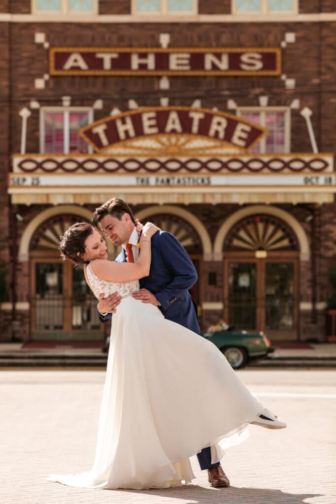 bride and groom standing outside of athens theatre