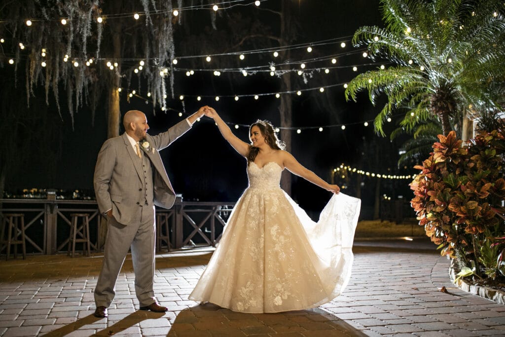 groom twirling bride on dance floor