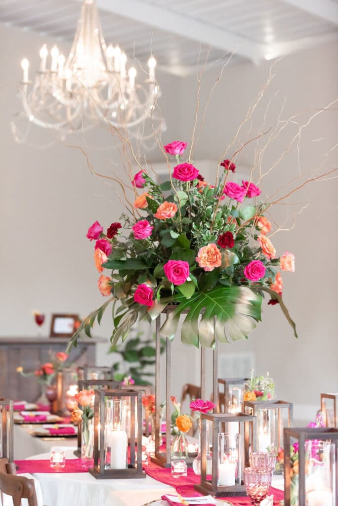long table set up with colorful flowers and candles at Cypress Creek Farmhouse
