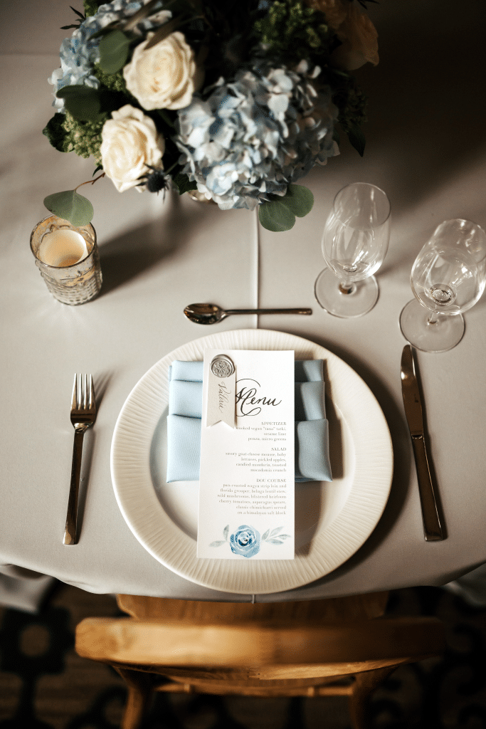 menu placed on plate for wedding reception