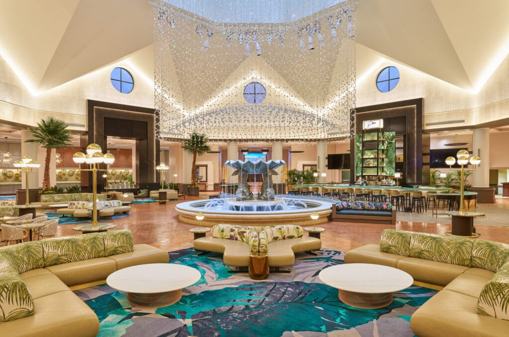 lobby area inside of Walt Disney World Swan and Dolphin Resort with tan couches and colorful rugs