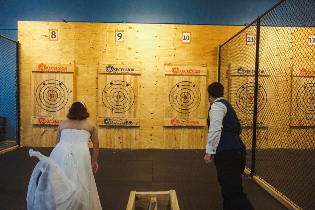 bride and groom throwing axes at Axecelsior Axe Throwing