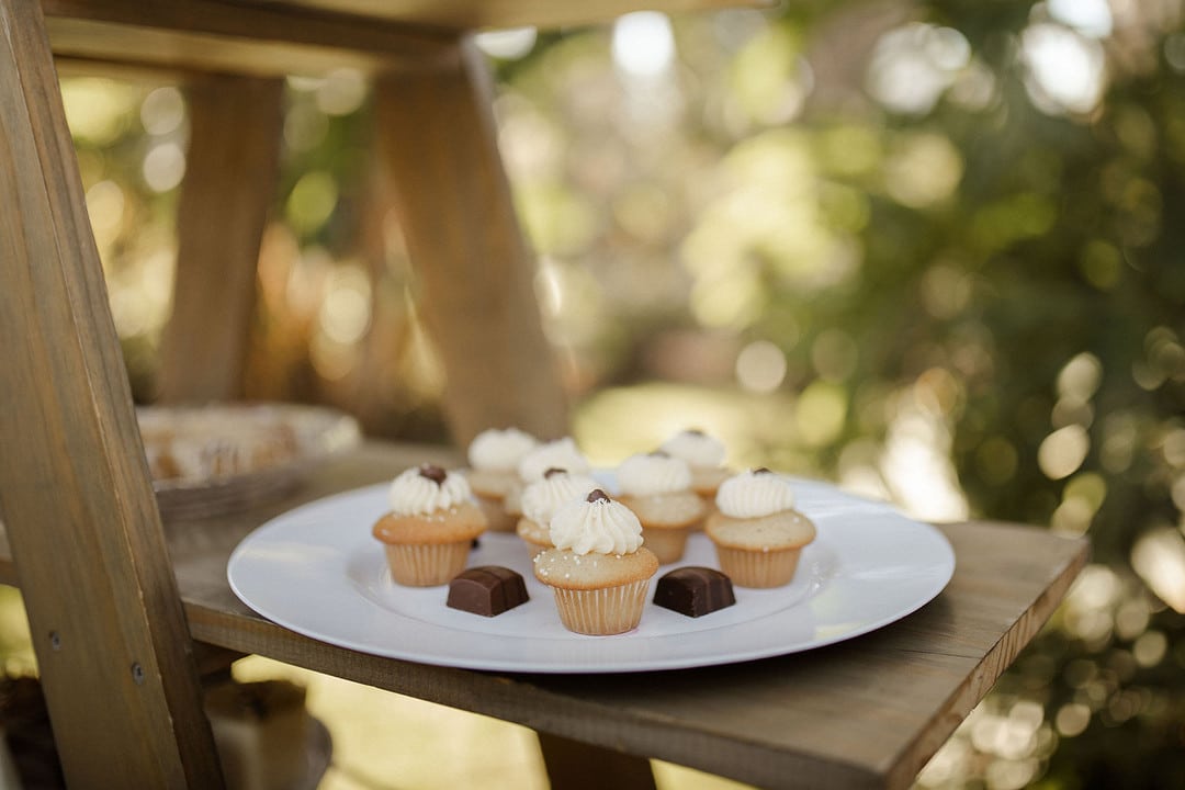 cupcakes displayed on a plate with chocolate pieces for the central florida boho wedding inspiration shoot