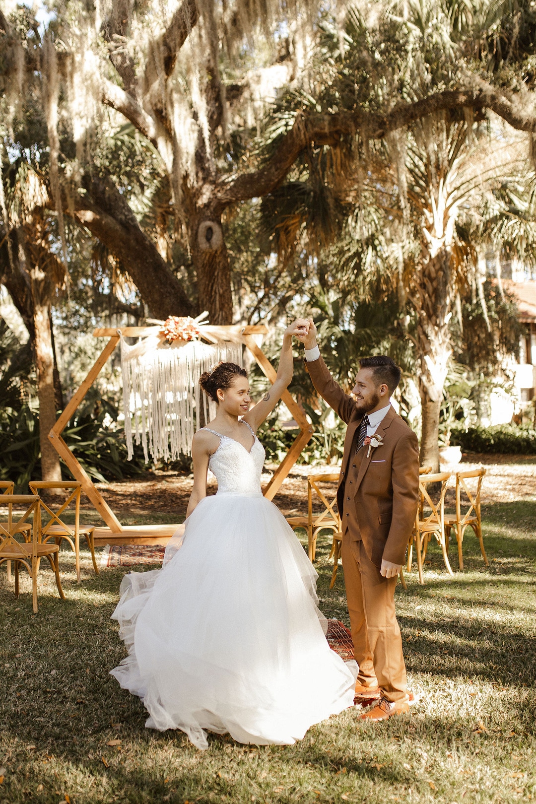 bride and groom dancing in front of their ceremony space for the central florida boho wedding inspiration shoot