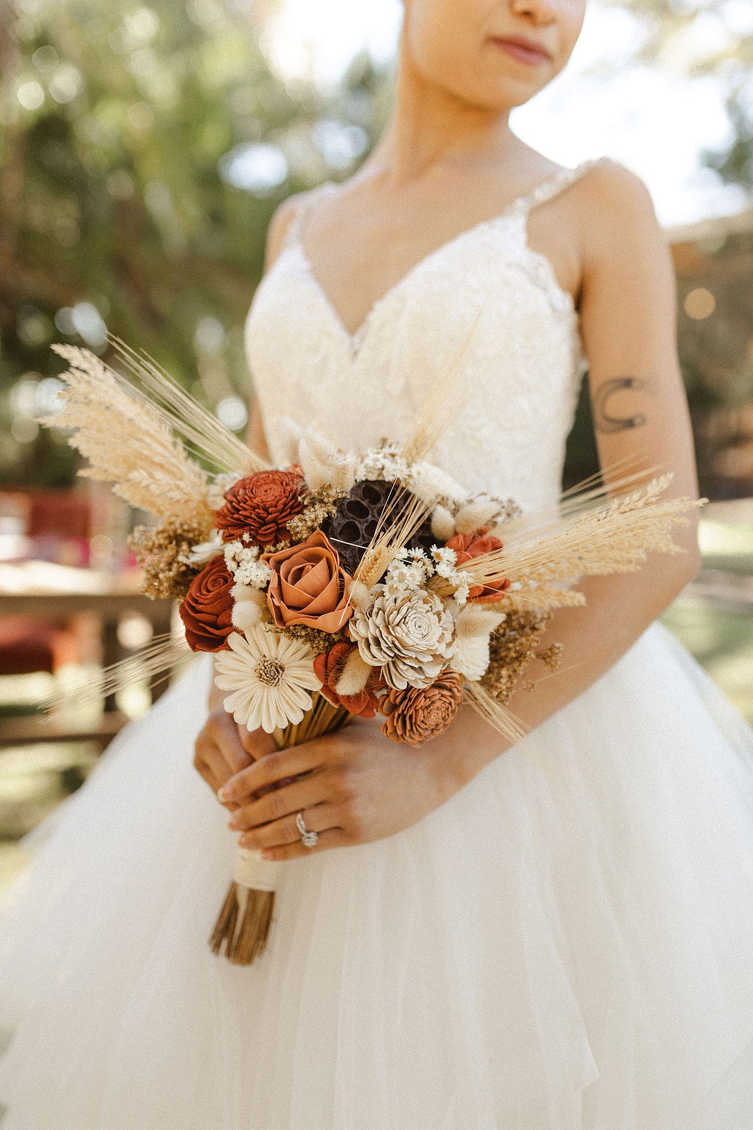 the bride holding her bouquet with neutral color tones