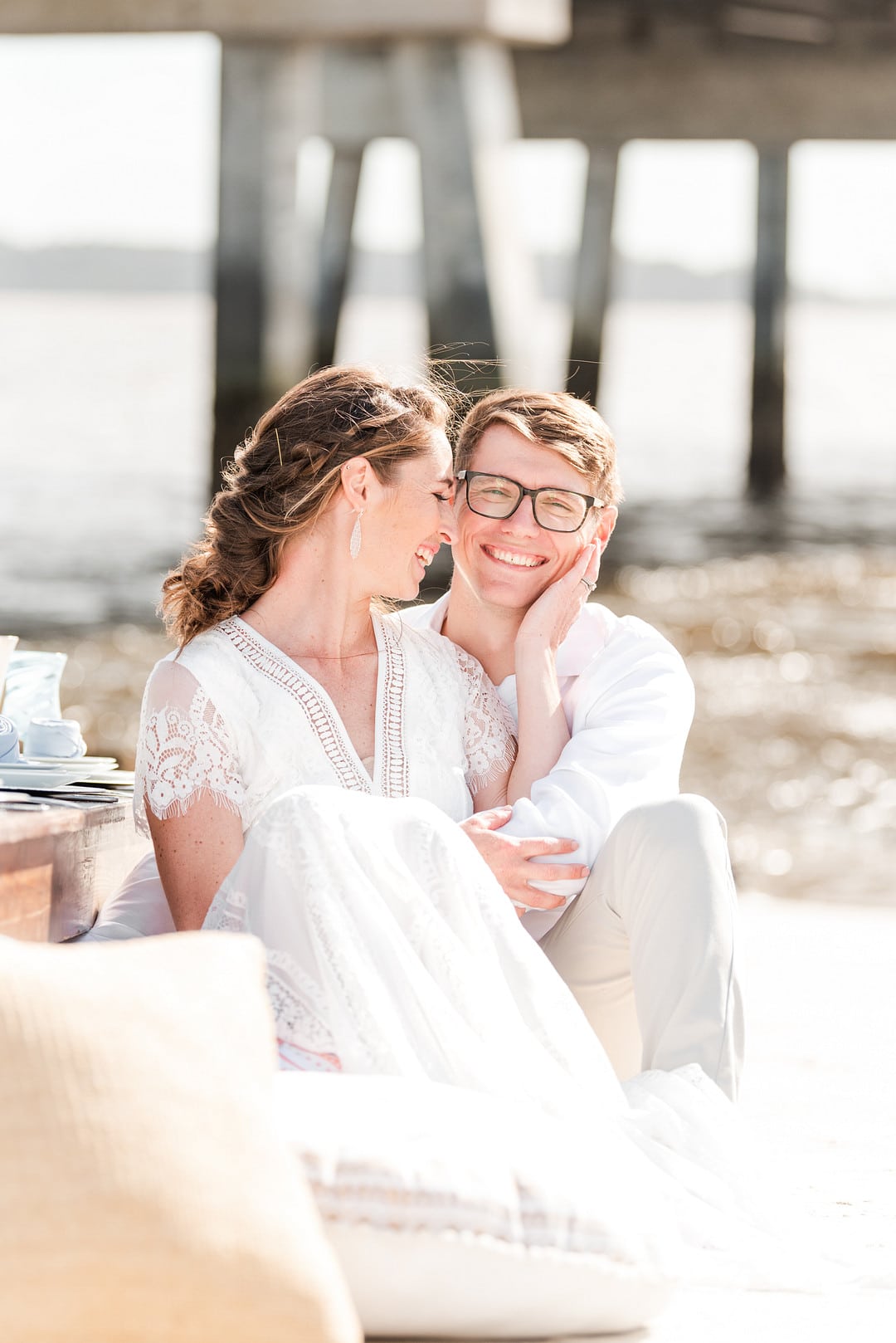 bride and groom cuddling on the beach for the amelia island beach wedding inspiration shoot