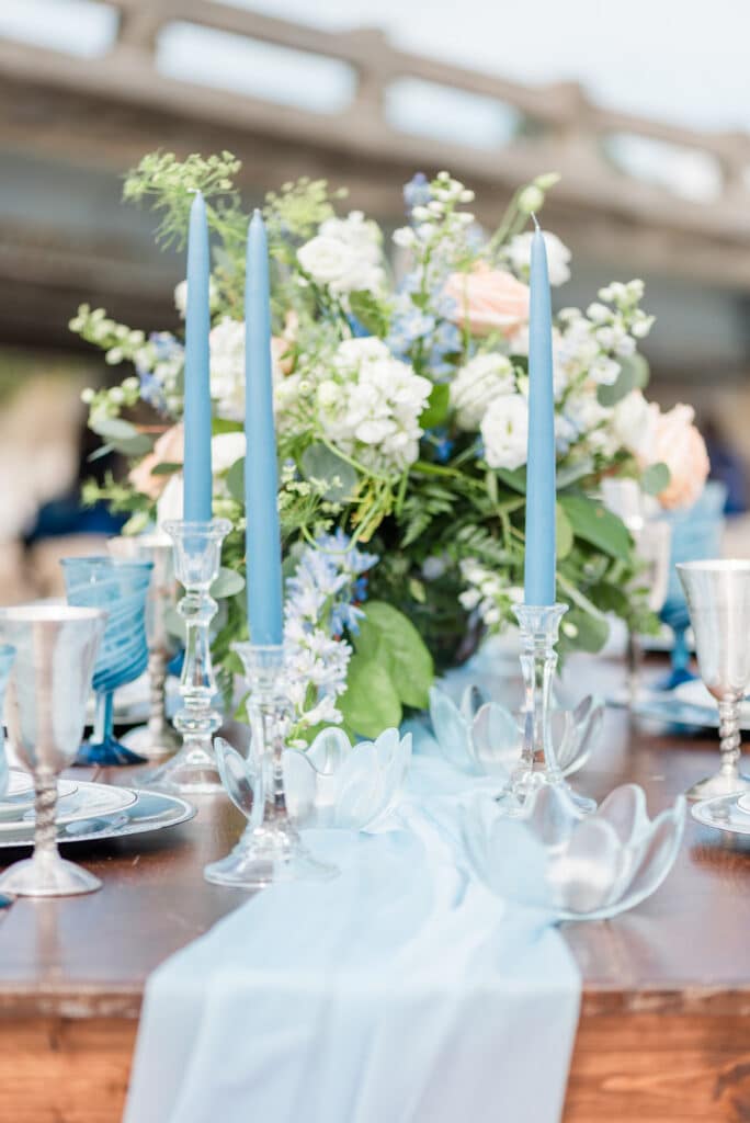 the table with candles, plates, and other accessories to match the amelia island beach wedding inspiration theme