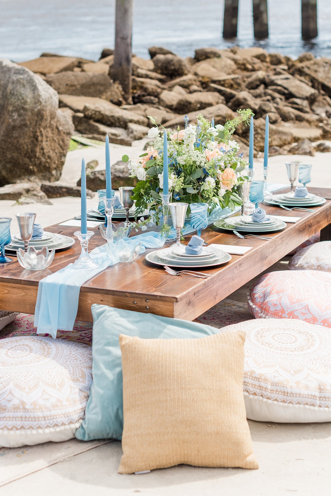 the table set up with pillows surrounding for the amelia island beach wedding inspiration shoot