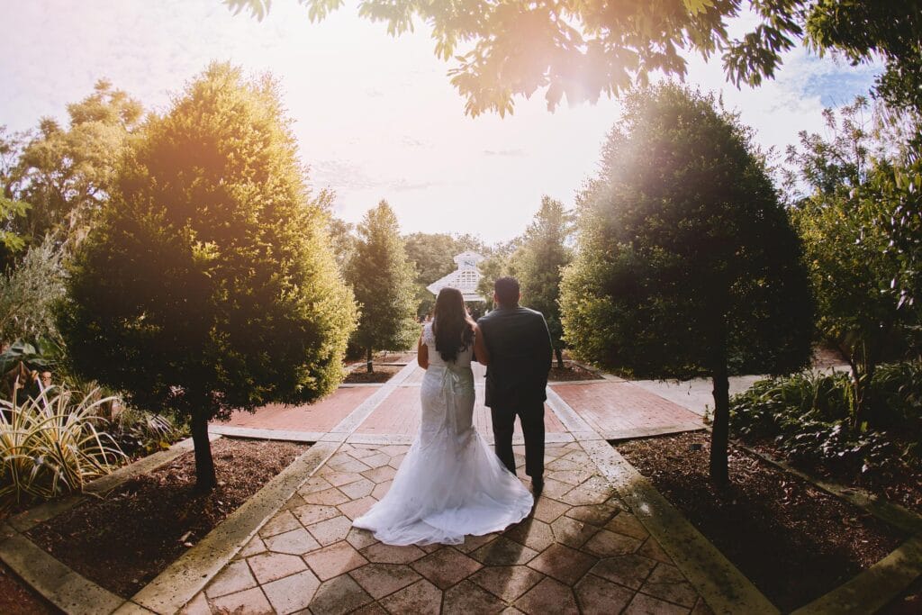 Bride and Groom on path into sunset