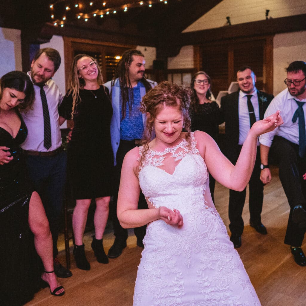 Bride playing air guitar during a song at the reception
