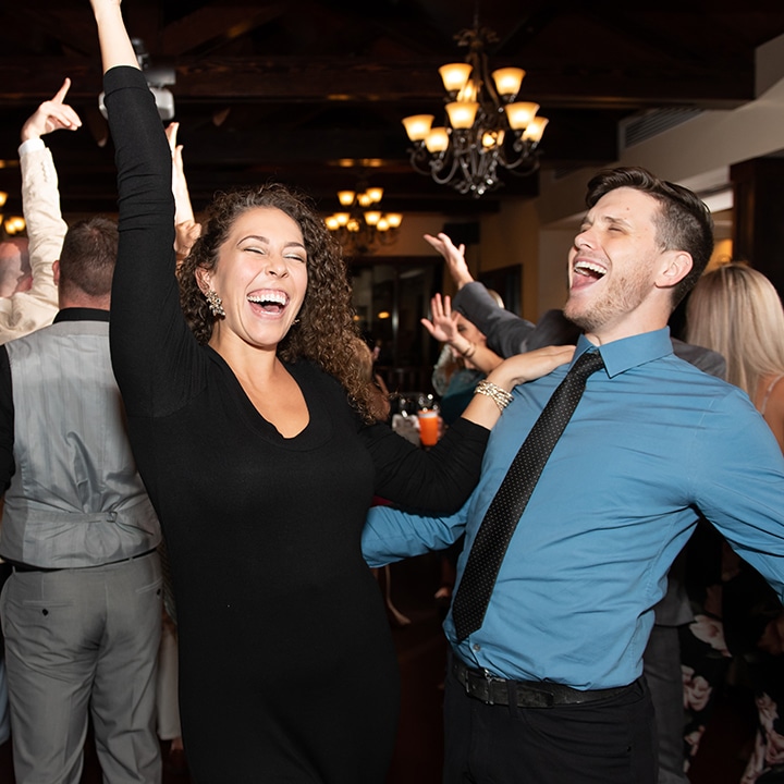 guests dancing and singing at a wedding