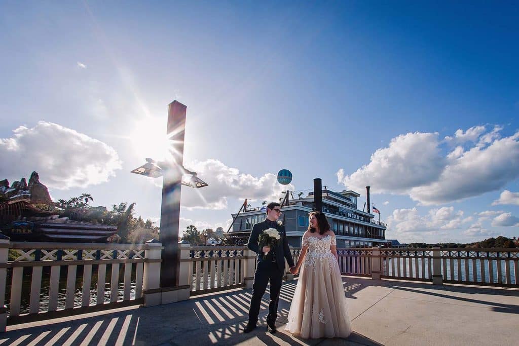 Bride and Groom with paddleboat behind them