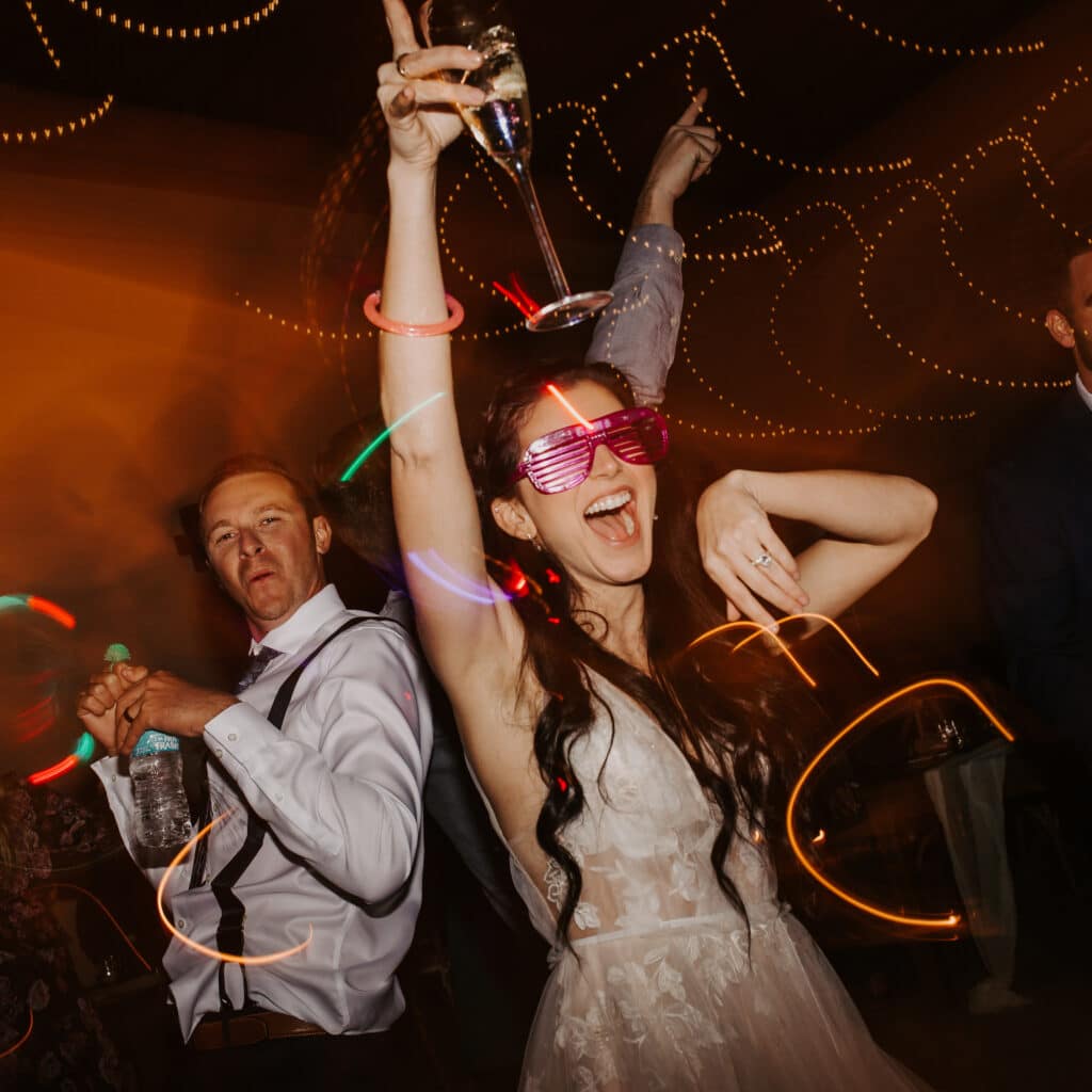Bride and groom dancing with fun colorful lights.