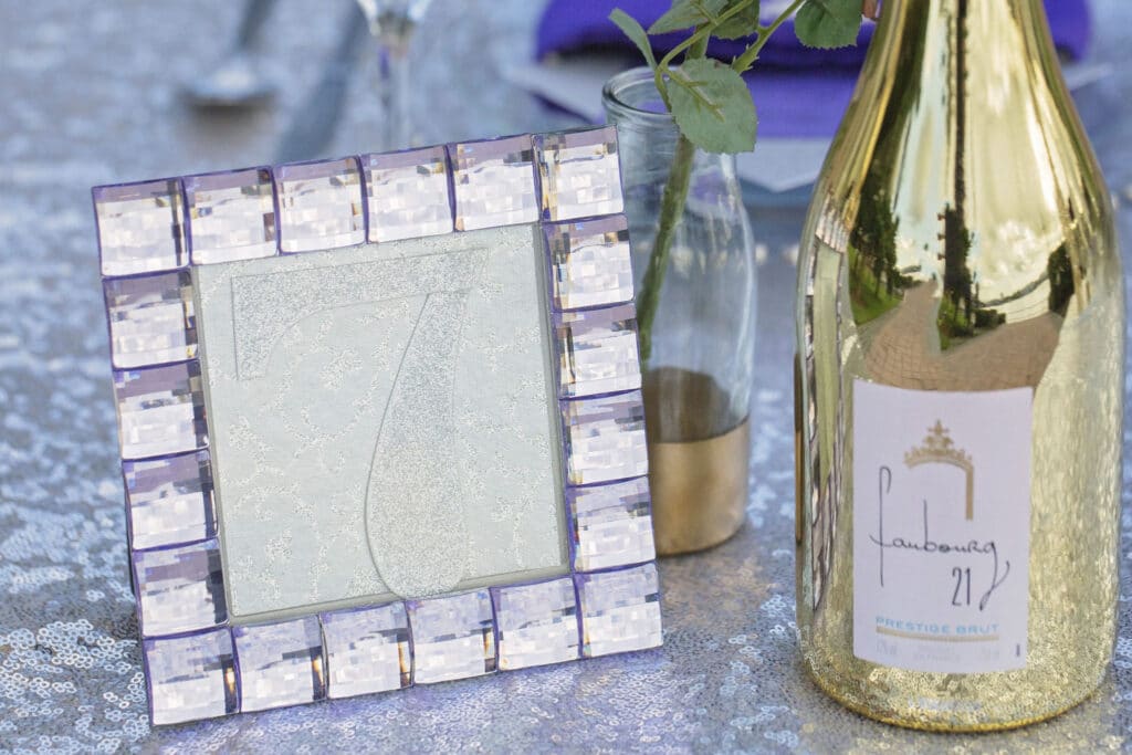 table number and a gold reflective wine bottle from ABC Fine Wine & Spirits