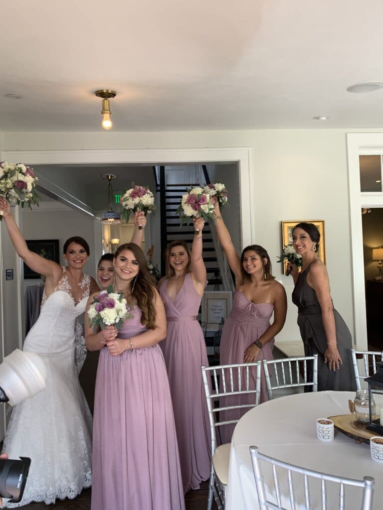 bride and her bridesmaids smiling before wedding ceremony