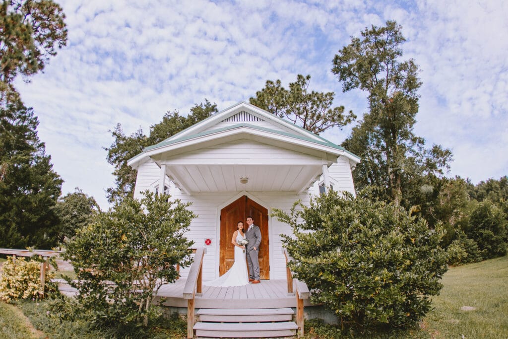 Bride and Groom in front of small chapel