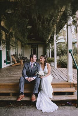 Bride and Groom sitting on stairs talking