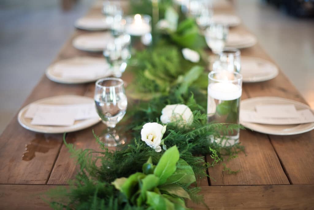 green and white flowers draped across a table