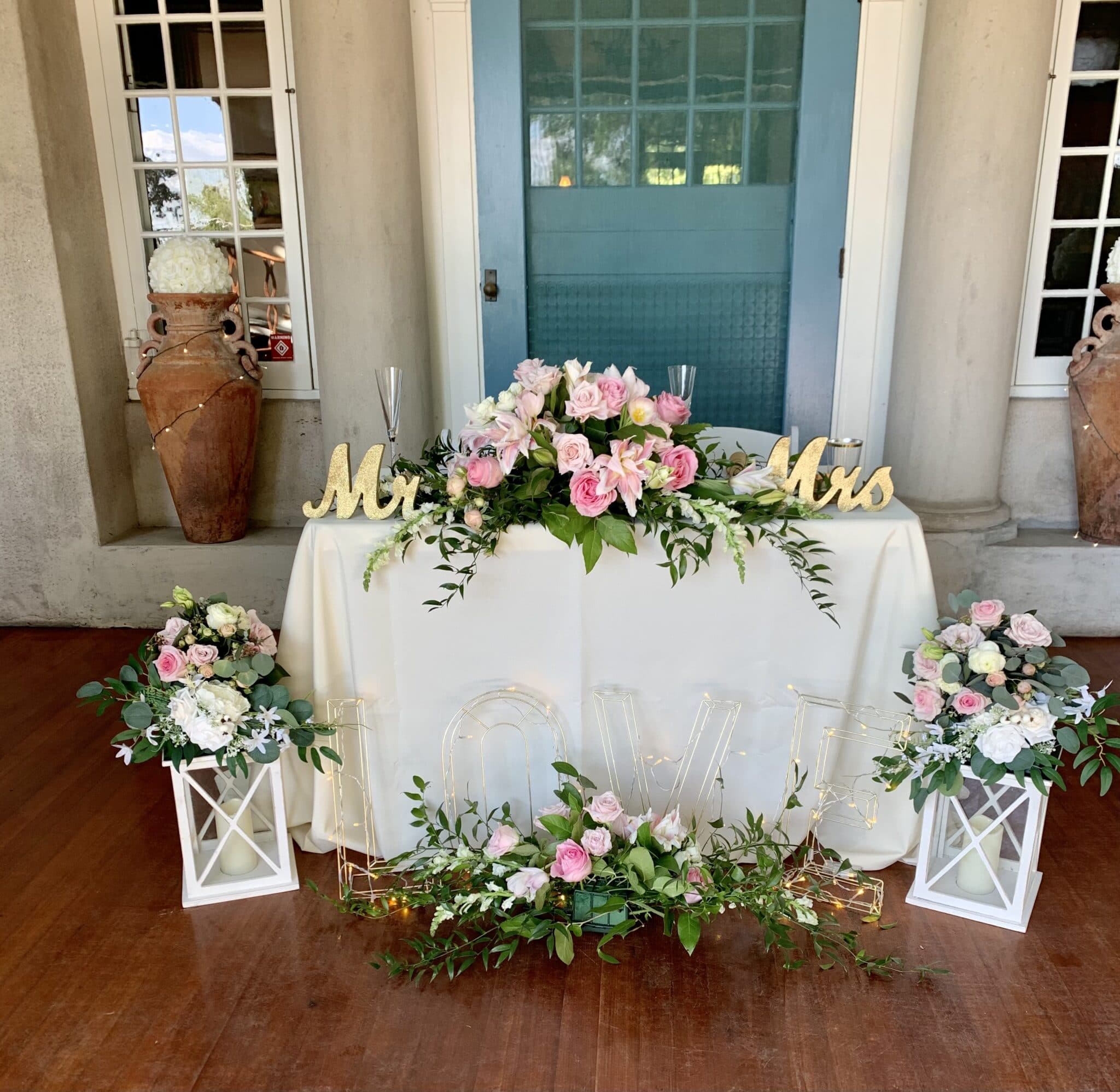 sweetheart table decorated with flowers and candles