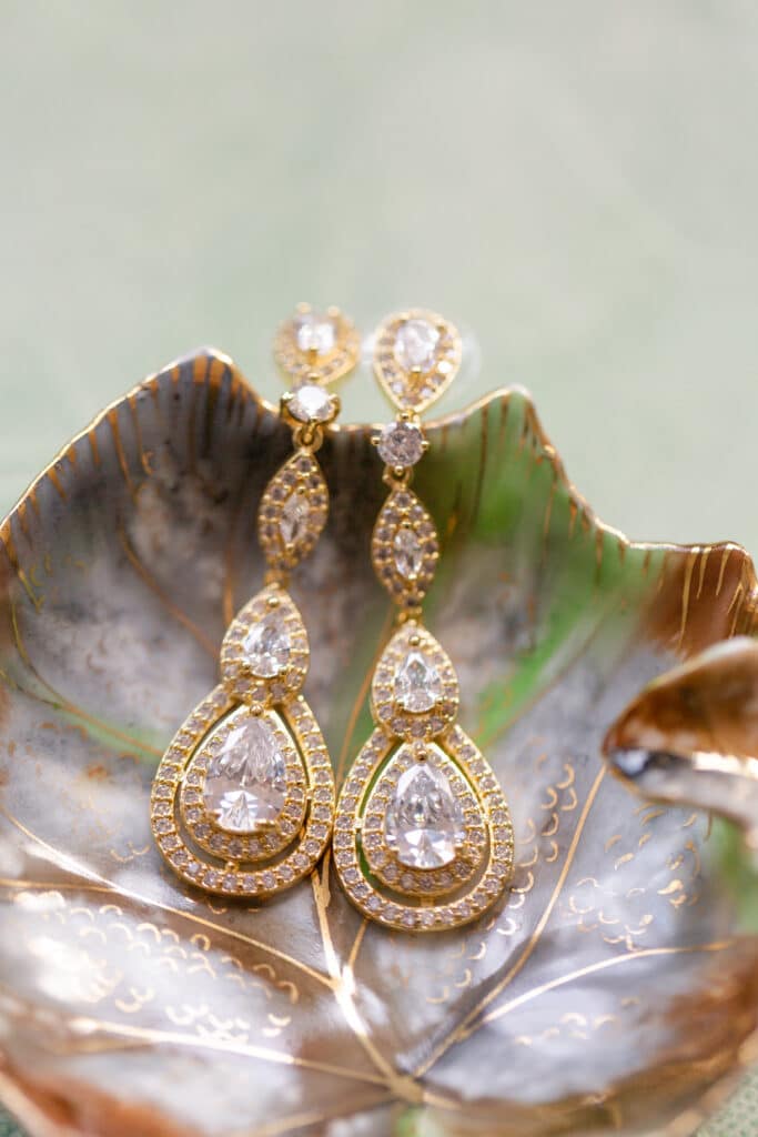 Christmas in July SS 106 - Christmas Themed Wedding Inspiration - Inspiration Shoot Bride's earrings. They are gold with diamonds throughout.