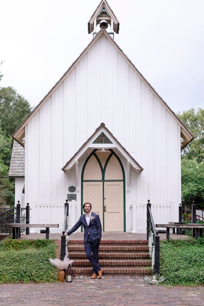 groom standing in front of the hall which is the venue of the picnic wedding inspiration shoot
