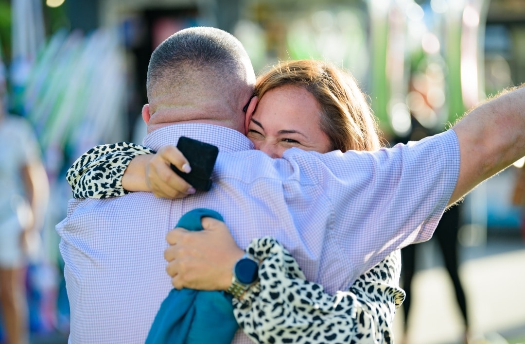 bride to be hugging the groom to be while holding the ring box in her hand after the orlando eye marriage proposal