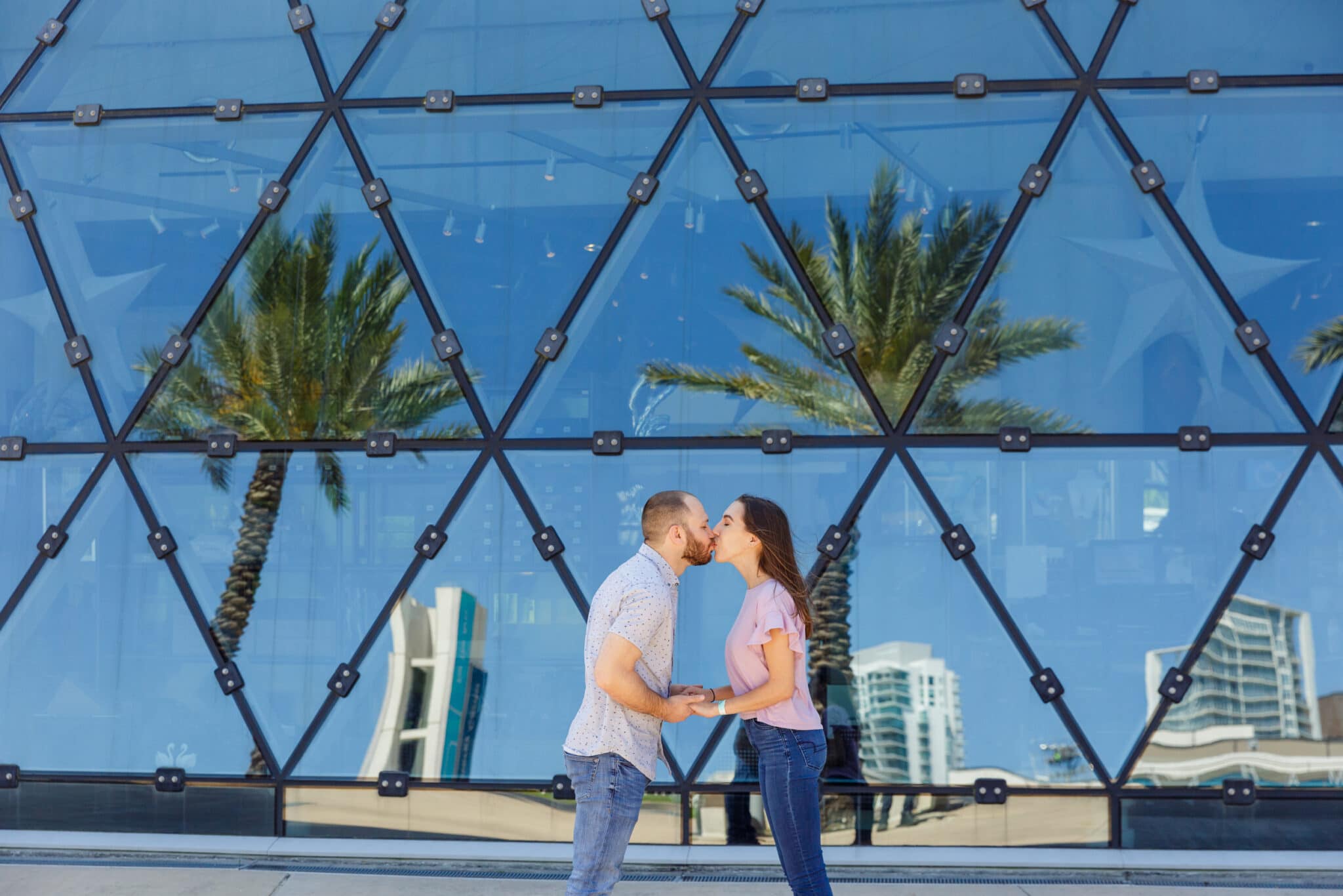 newly engaged couple kissing outside the museum after their salvador dali museum marriage proposal