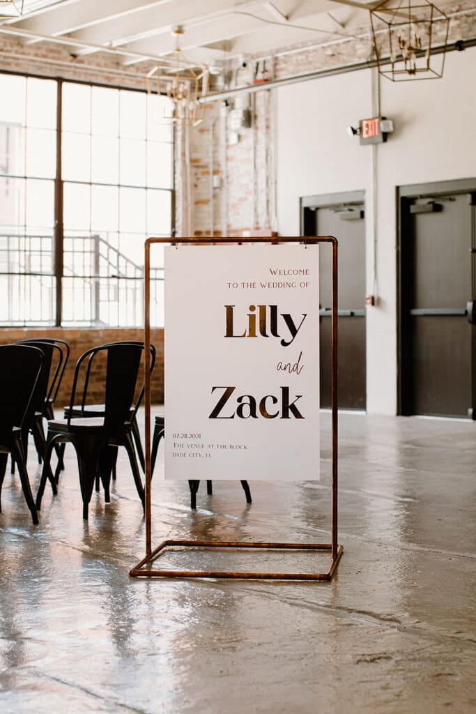 Summer Urban Loft Wedding Inspiration Grace Jicha Venue At The Block Wedding Installs 14 websize low - Urban Loft Wedding Inspiration - Styled Shoot large white and rose gold sign with the couple's names by their ceremony space.