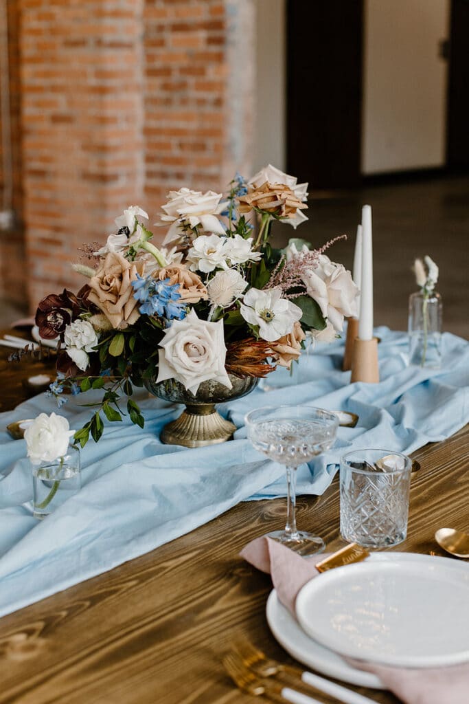 Summer Urban Loft Wedding Inspiration Grace Jicha Venue At The Block Wedding Tablescape 7 websize low - Urban Loft Wedding Inspiration - Styled Shoot the large flower center piece in the center of a reception table for the urban loft wedding inspiration.
