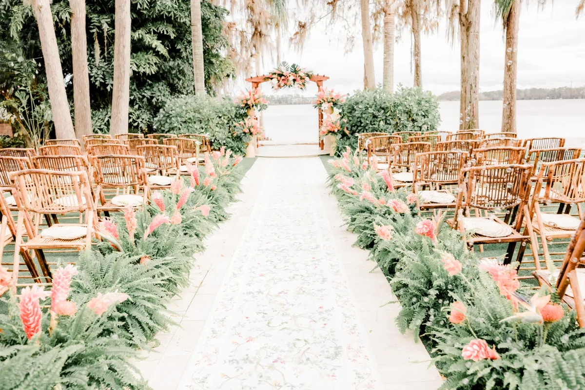 Outdoor wedding ceremony space at Paradise Cove Orlando decorated with lush tropical florals.