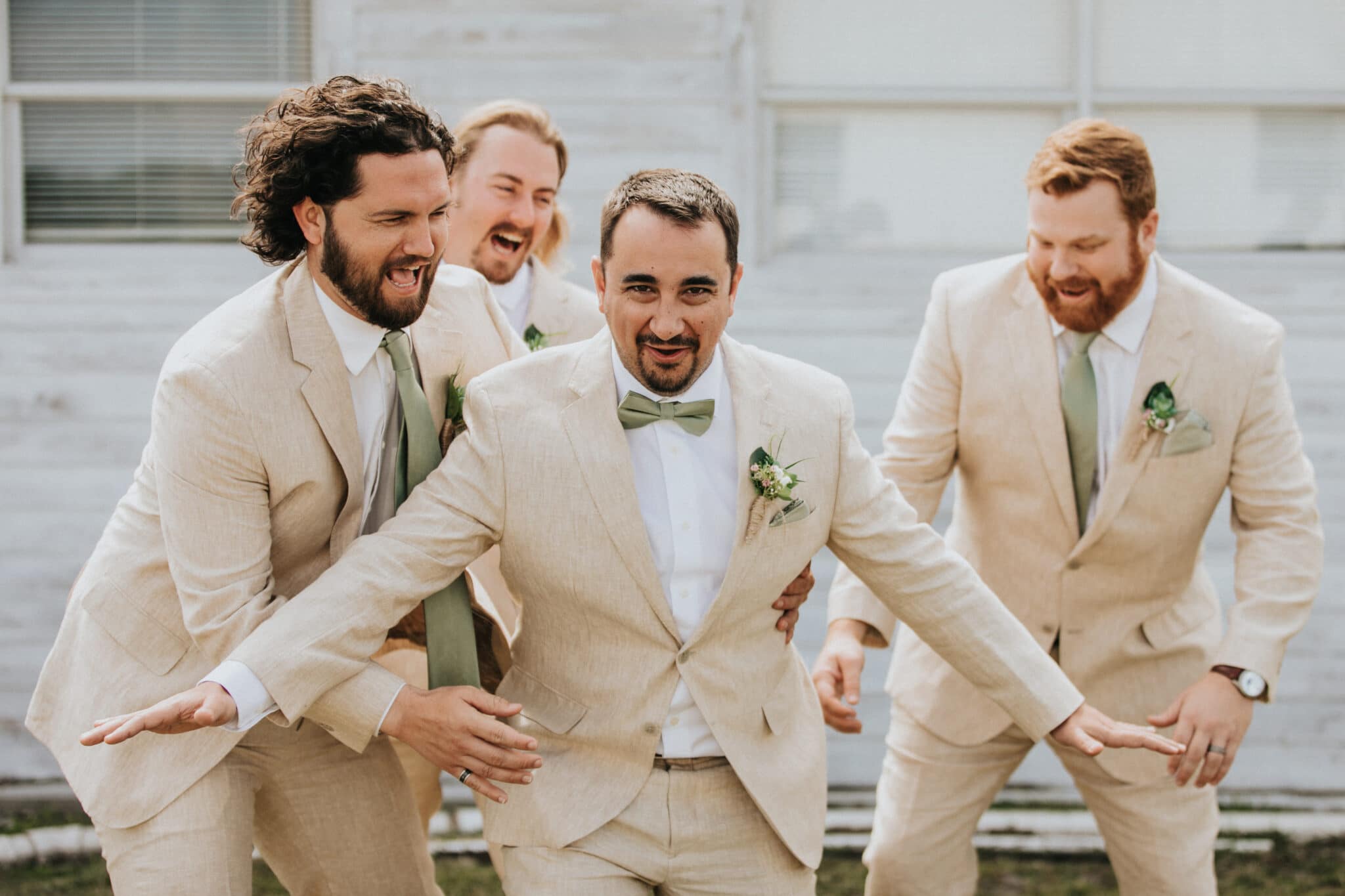 the groom and groomsmen in their wedding attire for the classic barn wedding.