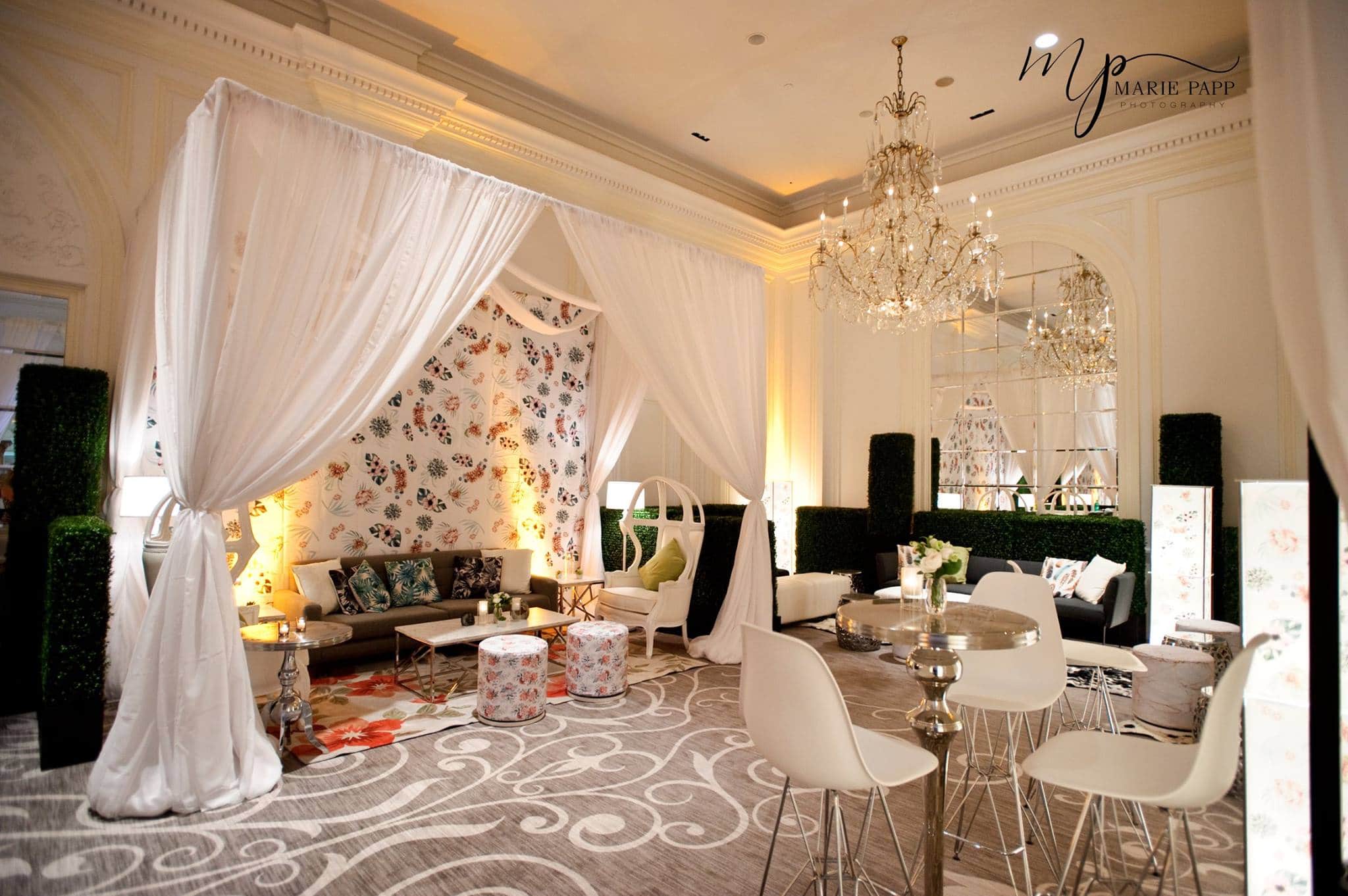 Fun lounge with paisley print, modern chairs and grey swirl rug