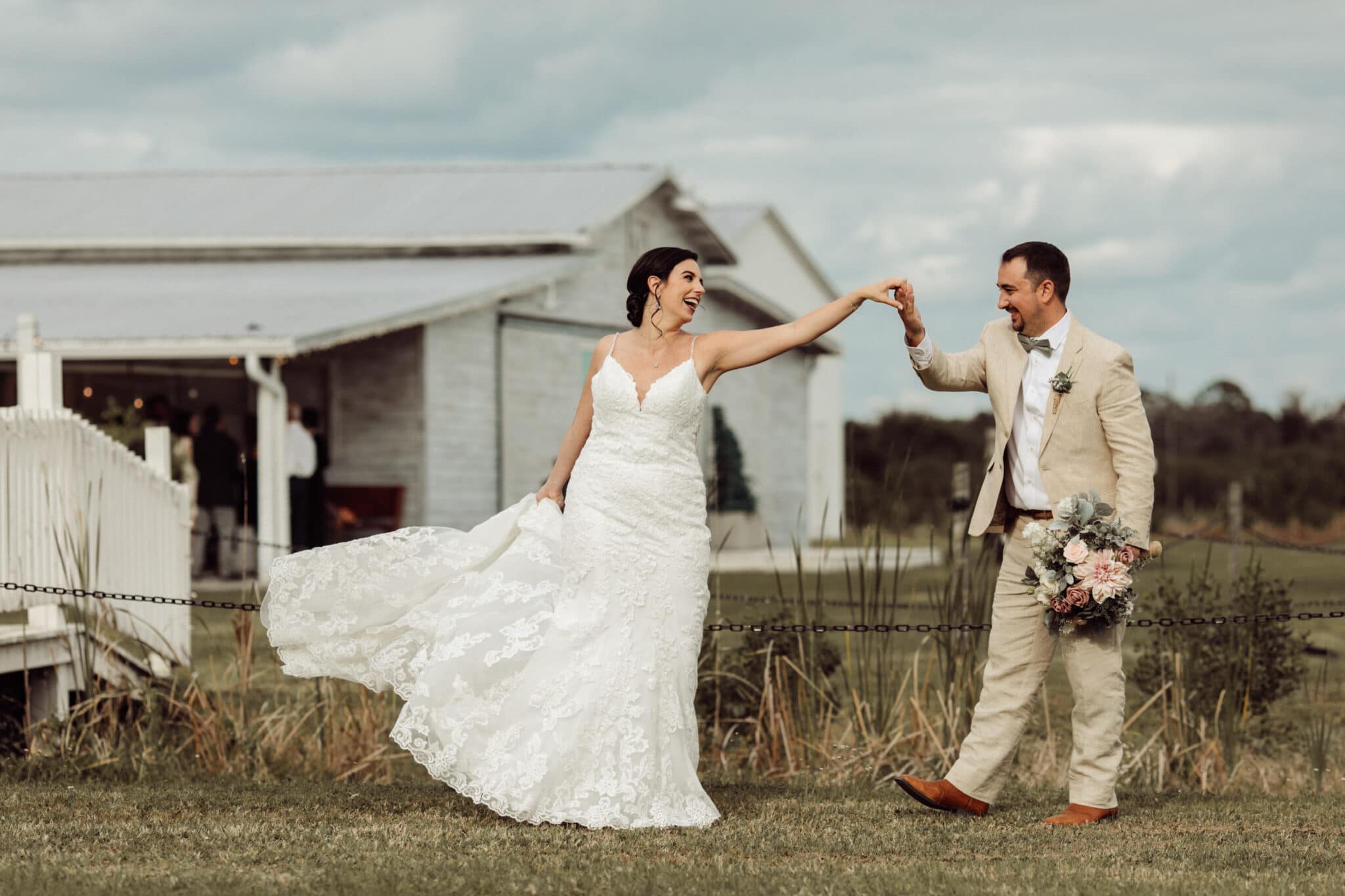 bride and groom dancing outside of their classic barn wedding.