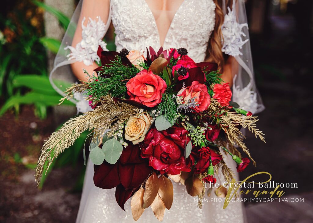 Bride with lace cape on and bouquet with grass fronds