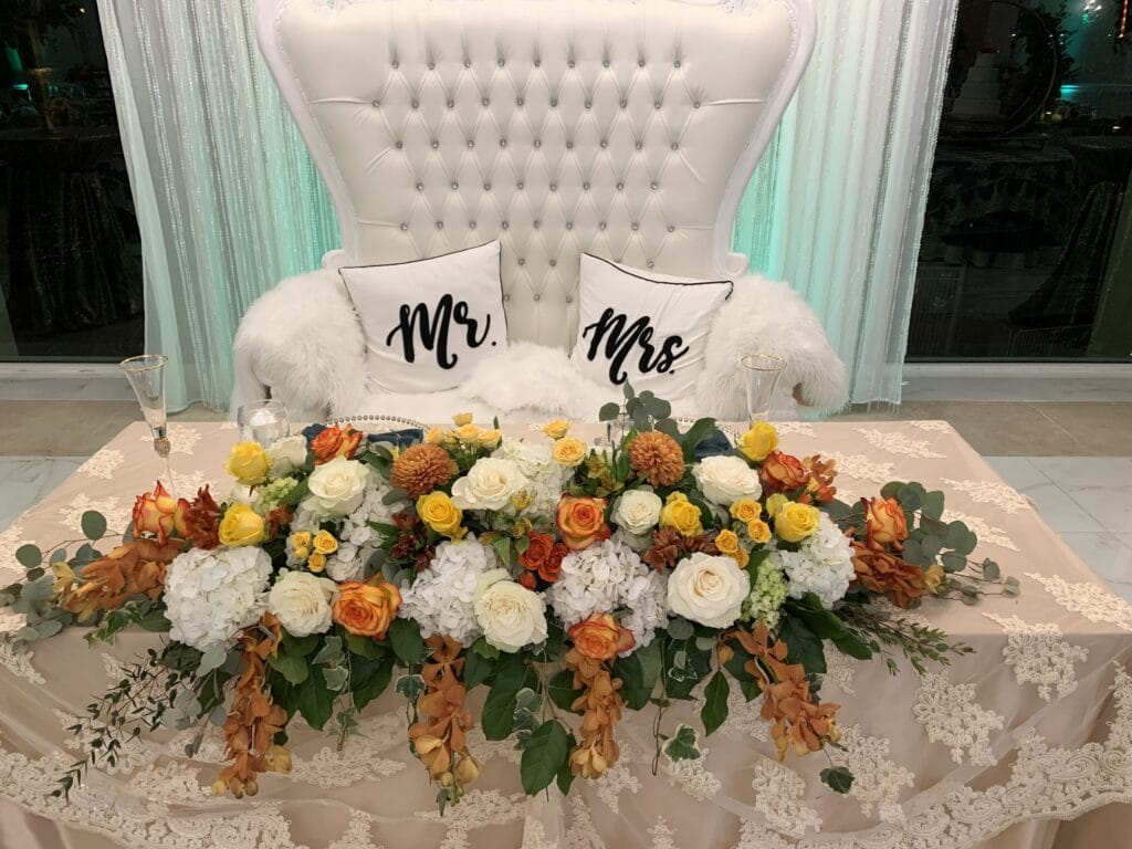 Sweetheart table with fall colored table centerpiece