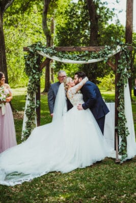 Bride and groom kissing after tying the knot.