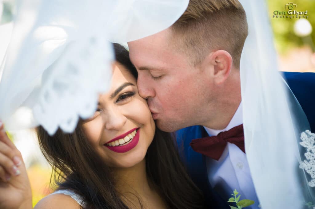 Close up of groom kissing a bride on her cheek
