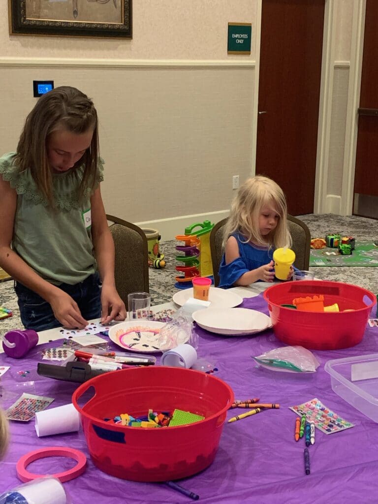 Children doing arts and crafts at a wedding