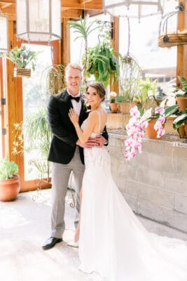 Bride and groom in an embrace smiling for the camera
