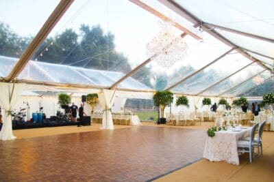 Band setting up under a tent for a wedding