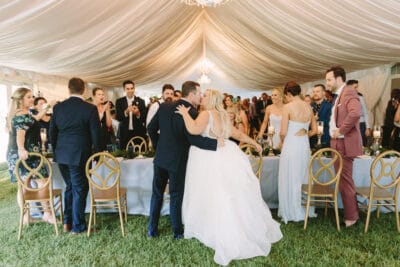 Bride and groom kissig at their table