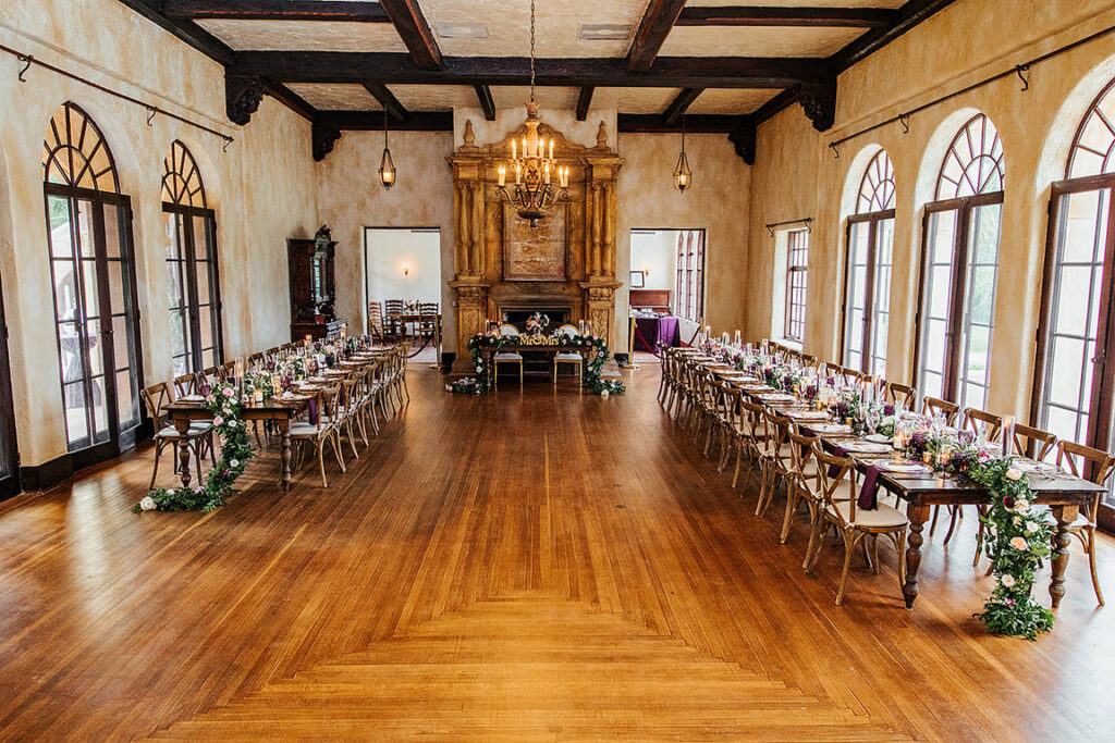 Long tables in a rustic room with a wooden floor