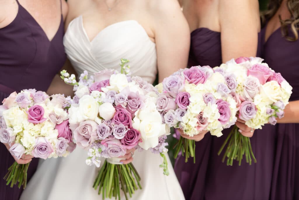 Bride with bridesmaids in black and pink and white bouquets