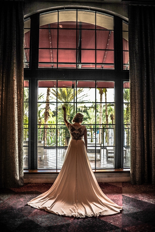 Bride facing away from the camera near a window