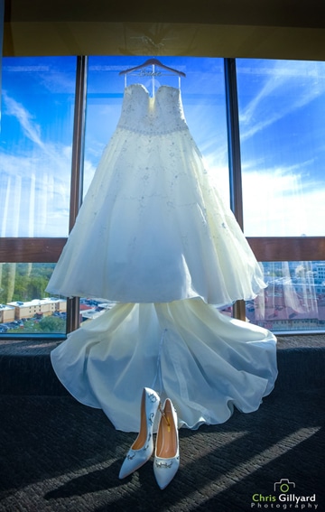 wedding dress waiting for bride against window and sky